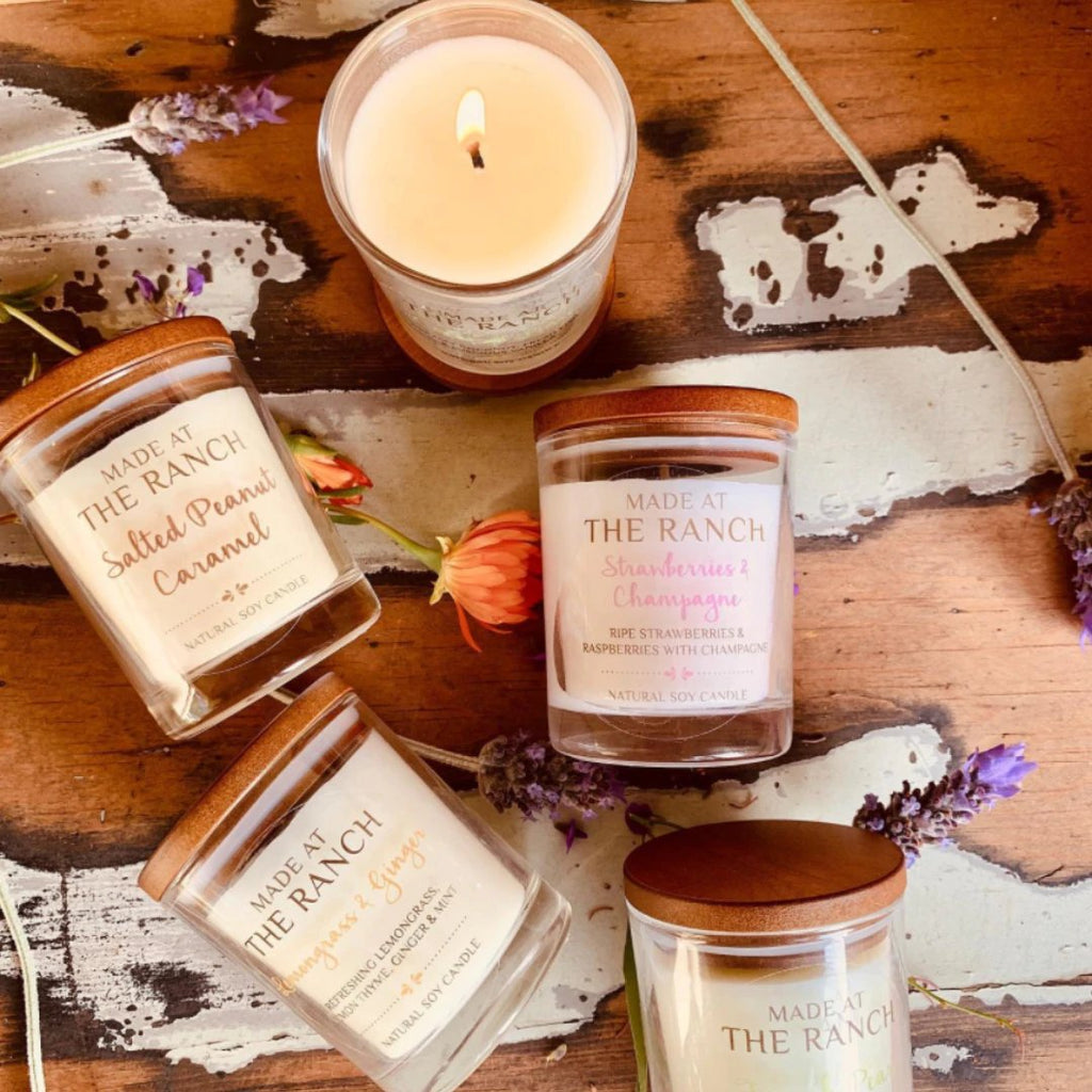 collection of candles laying on a wooden top table 