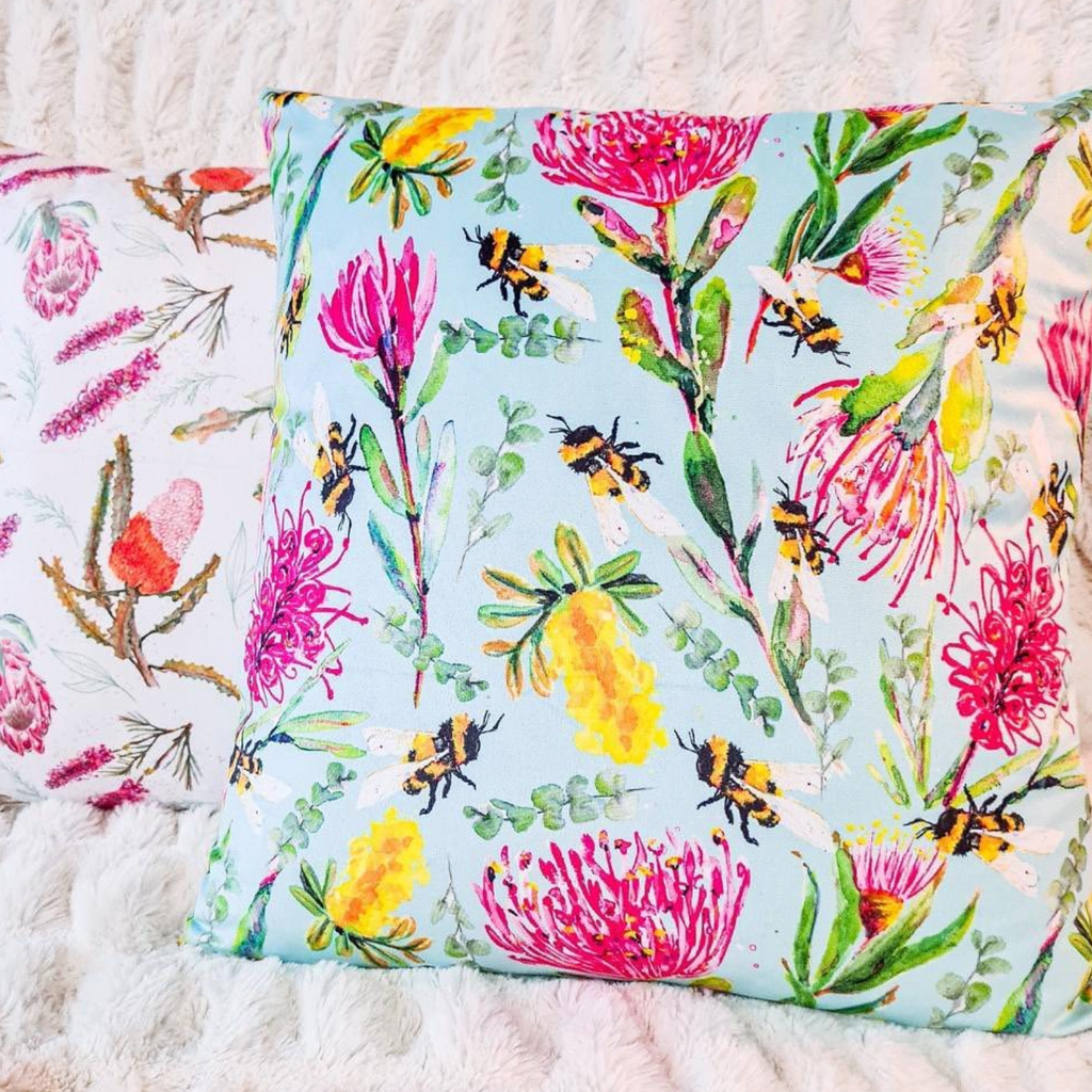 Australian bees and florals brightly coloured yellow, pink and blue cushion. 